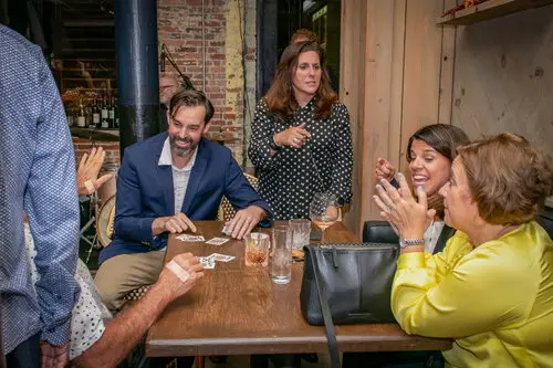 Adam Stone performing card magic for his friends