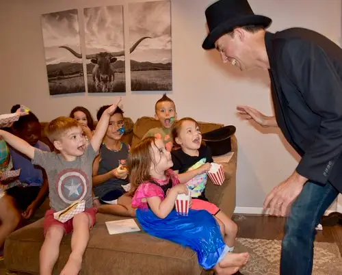 Magician Adam Stone with children's on holiday
